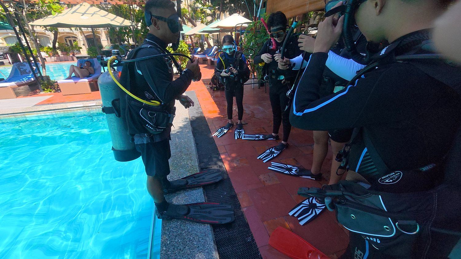 First-time divers gearing up beside the pool before their session